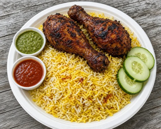 Two grilled Al Fahm chicken drumsticks on yellow mandi rice with chutneys